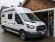 Tall cargo van entering a residential garage safely