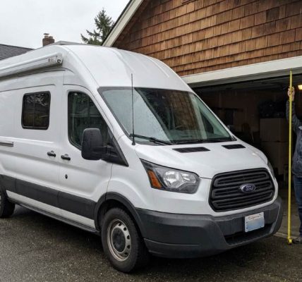 Tall cargo van entering a residential garage safely