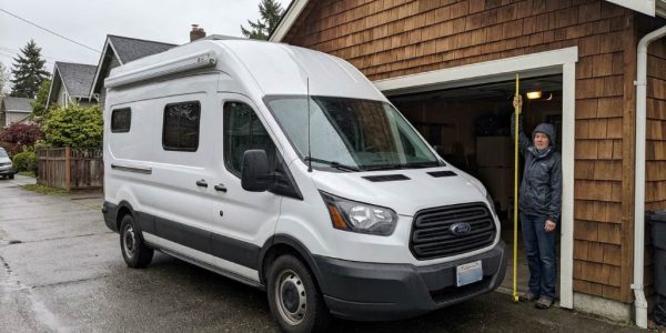 Tall cargo van entering a residential garage safely