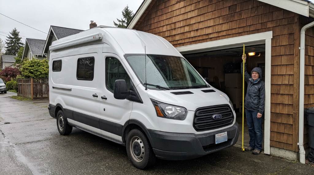 Tall cargo van entering a residential garage safely