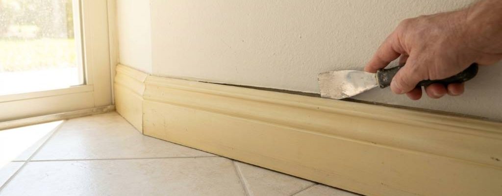 Technician tightening loose exterior skirting panel