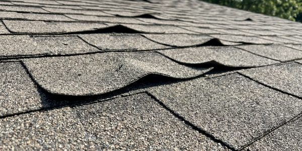 Curling shingles signal roof aging, moisture trapping, or bad ventilation. Learn what curling means for your home and how to prevent costly leak repairs.